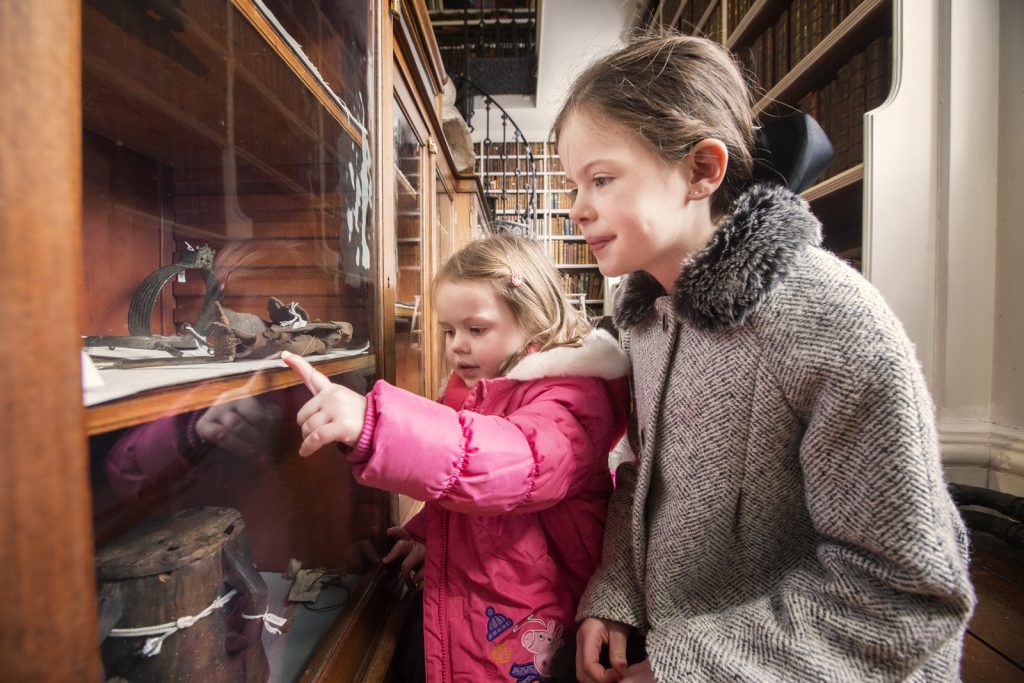 Children looking at the Beresford archeological collection